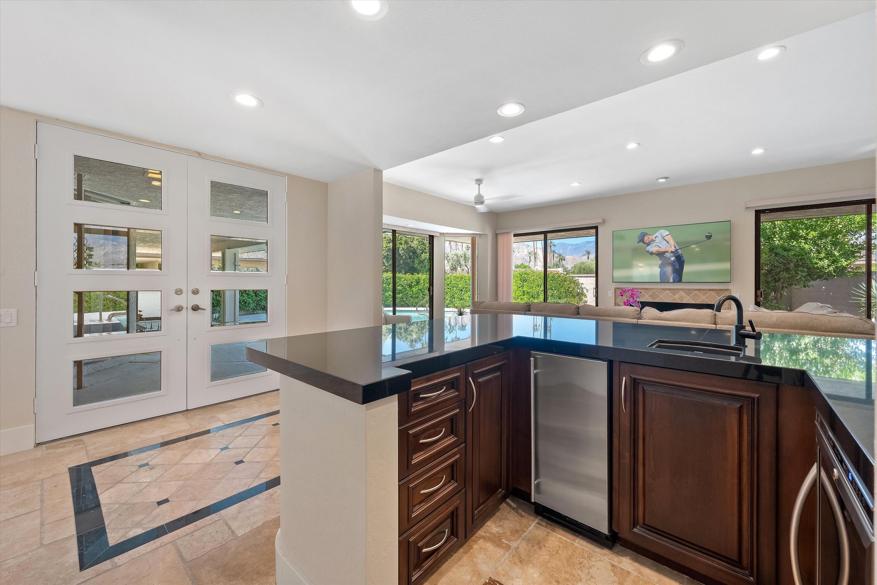 62 Dartmouth Drive Rancho Mirage, CA 92270 - Photo 17 of 46 a kitchen with granite countertop a sink and a stove