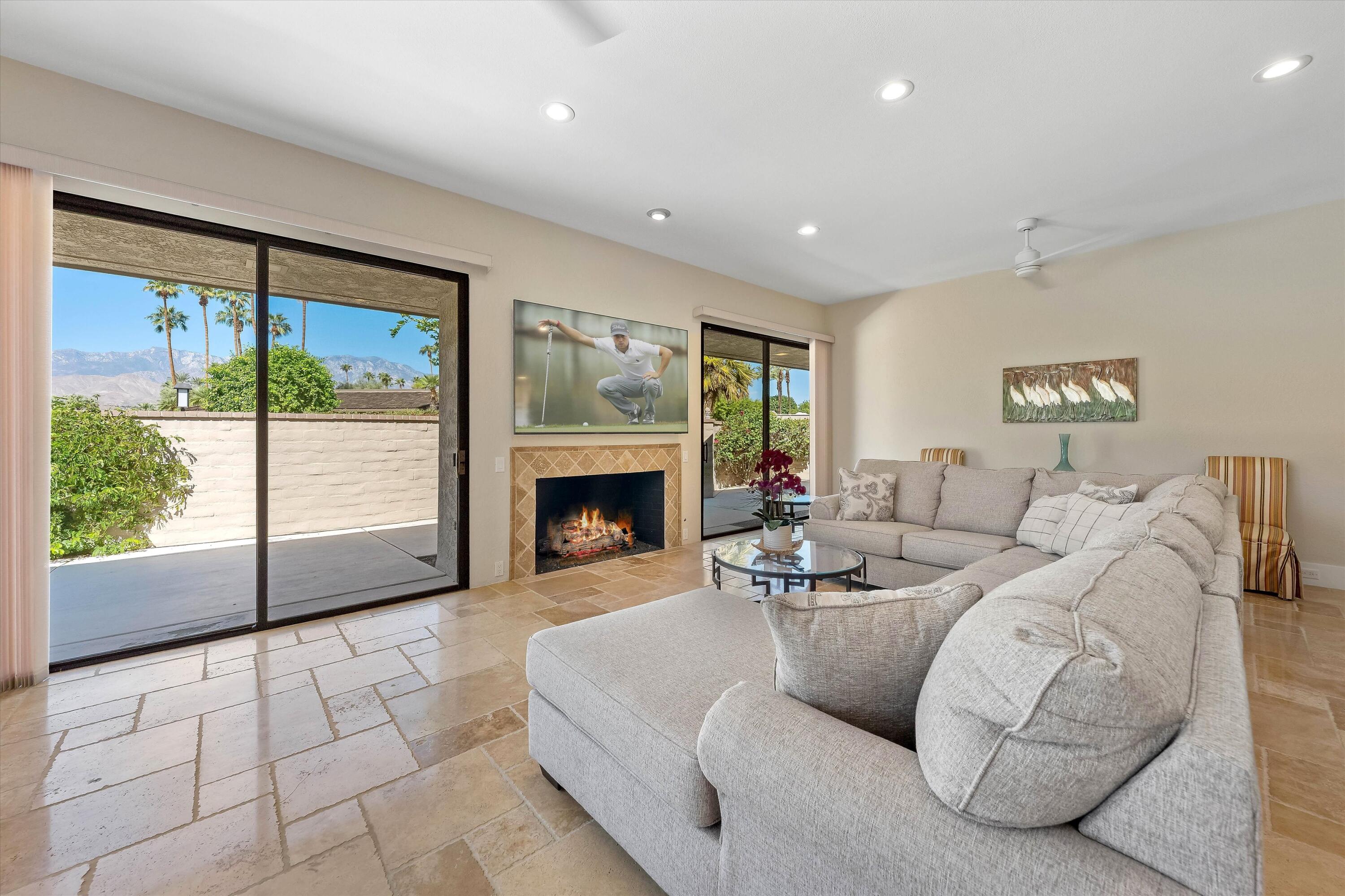 62 Dartmouth Drive Rancho Mirage, CA 92270 - Photo 20 of 46 a living room with furniture large window and a fireplace