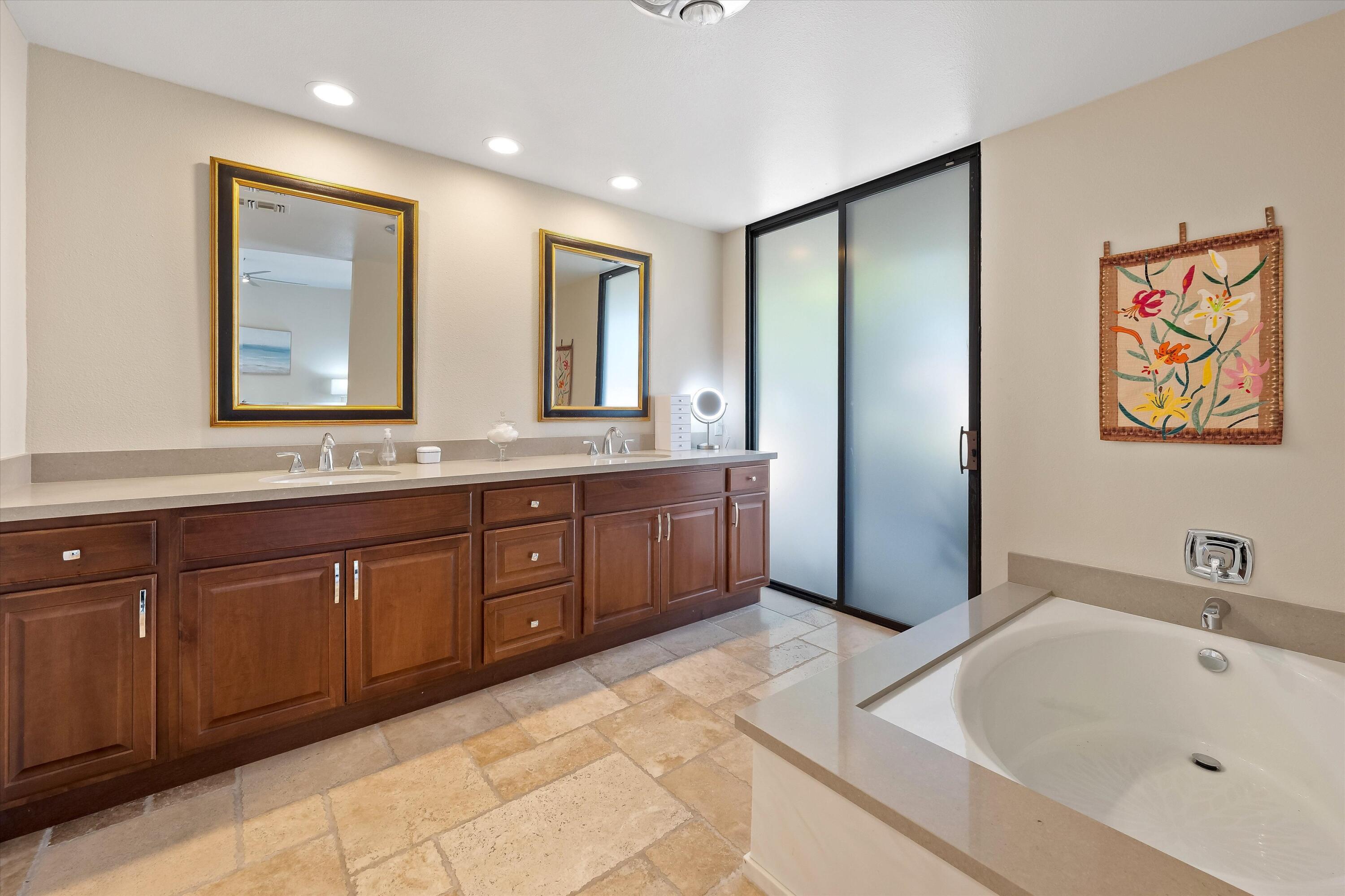 62 Dartmouth Drive Rancho Mirage, CA 92270 - Photo 27 of 46 a spacious bathroom with a double vanity sink mirror and bathtub