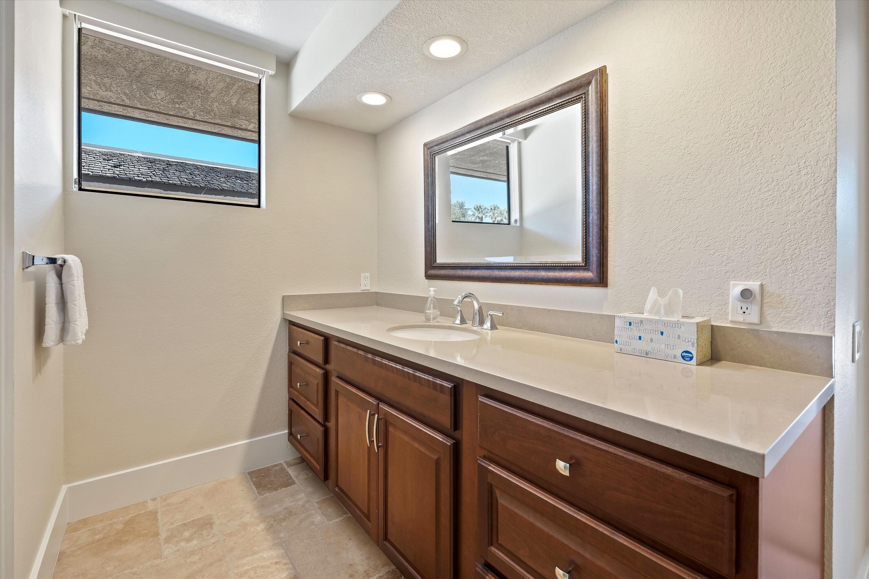 62 Dartmouth Drive Rancho Mirage, CA 92270 - Photo 32 of 46 a bathroom with a sink and a mirror