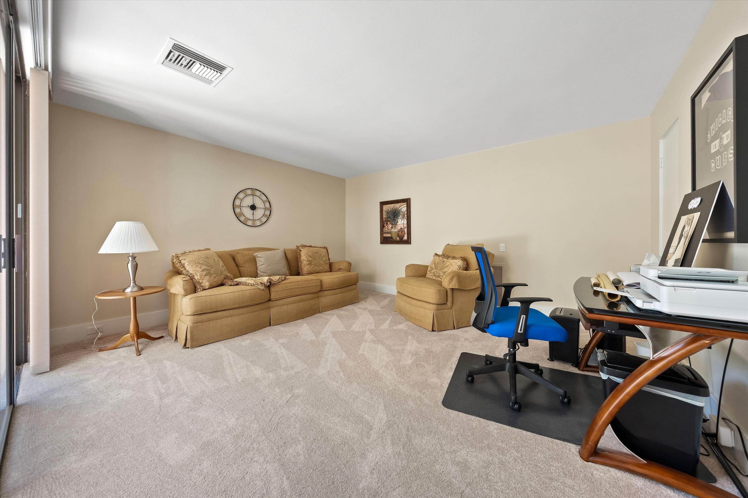 62 Dartmouth Drive Rancho Mirage, CA 92270 - Photo 33 of 46 a living room with furniture gym equipment and a flat screen tv