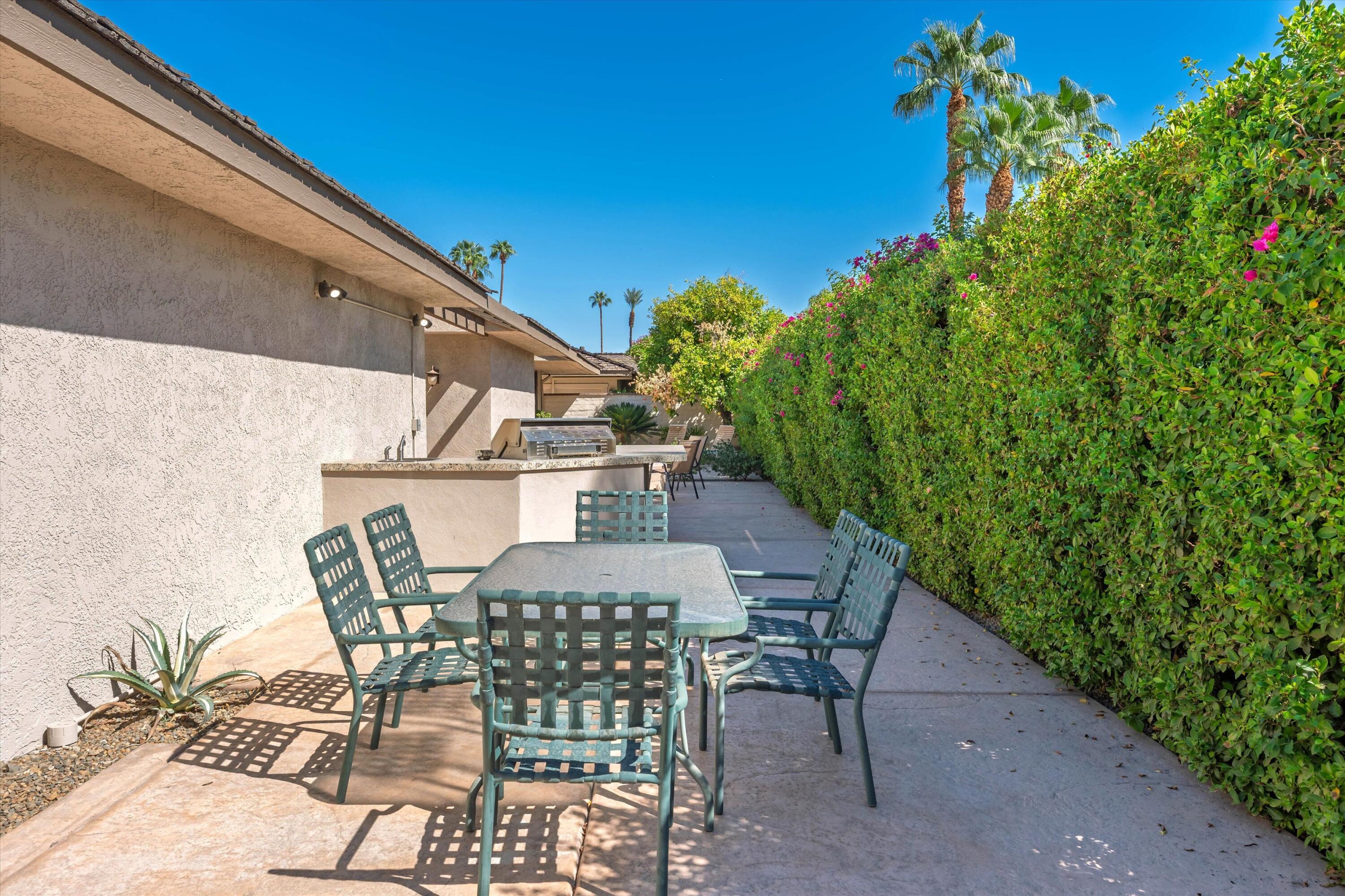 62 Dartmouth Drive Rancho Mirage, CA 92270 - Photo 39 of 46 a view of backyard with seating space and trees