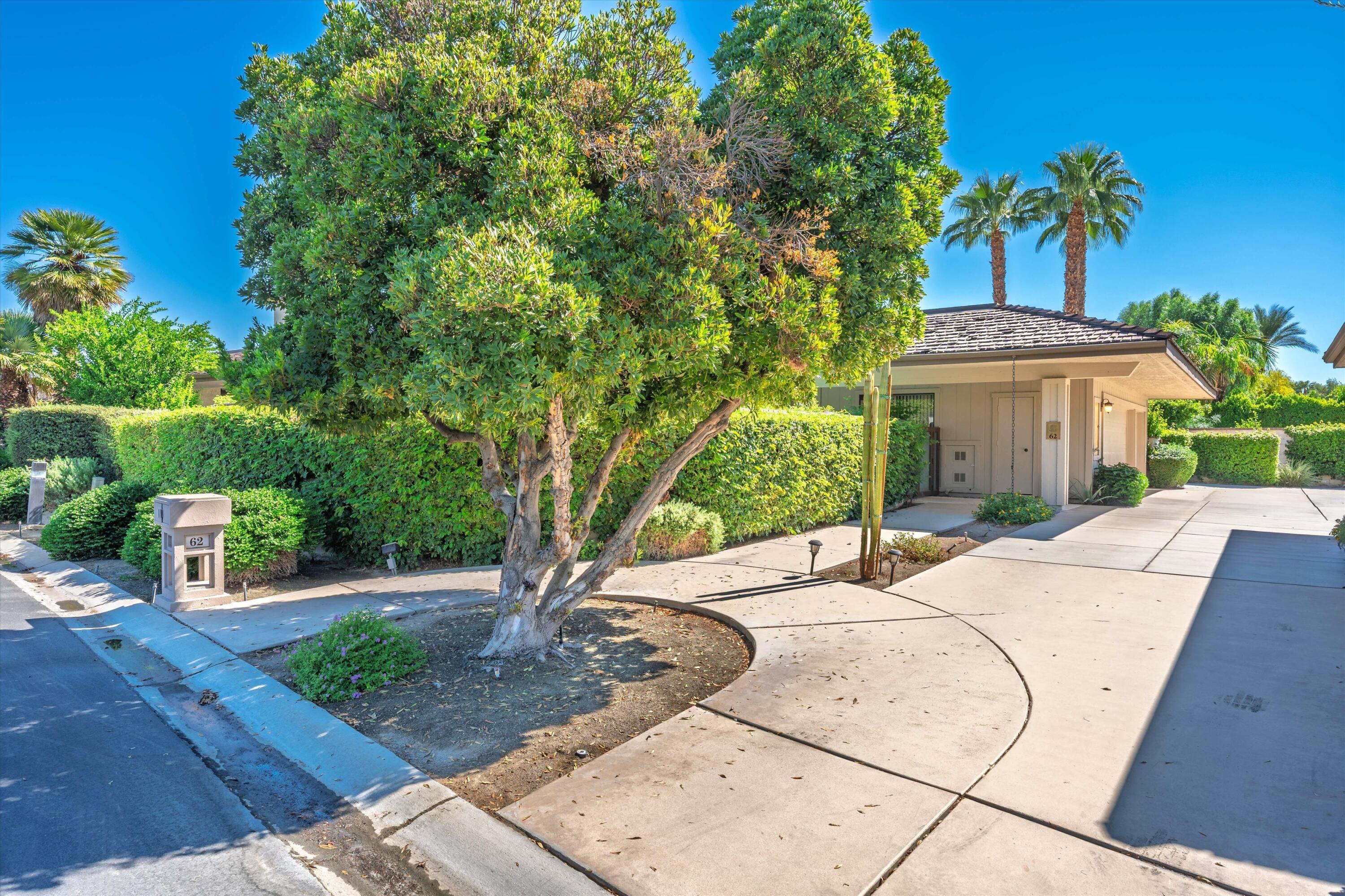 62 Dartmouth Drive Rancho Mirage, CA 92270 - Photo 42 of 46 a patio with a table and chairs under an umbrella