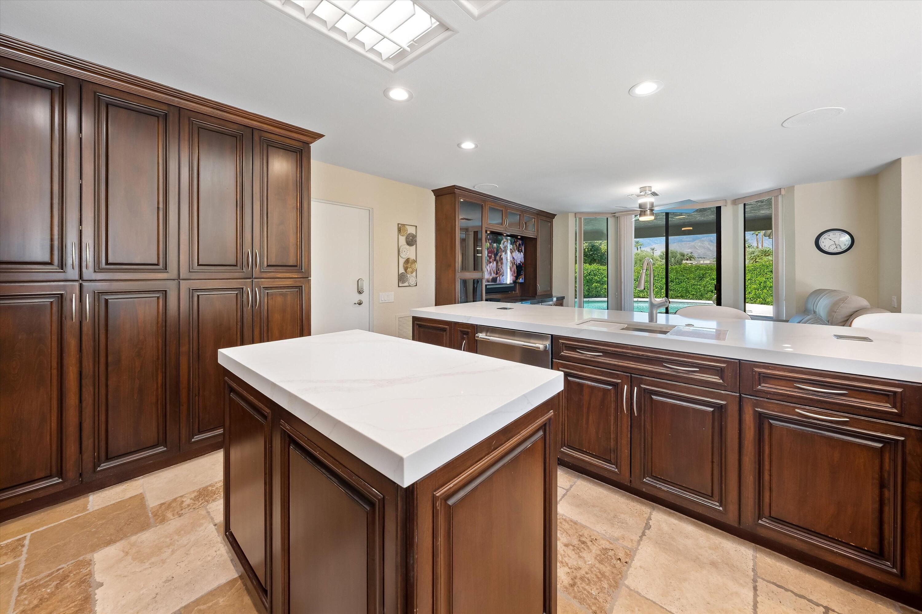 62 Dartmouth Drive Rancho Mirage, CA 92270 - Photo 9 of 46 a kitchen with a sink refrigerator and large window