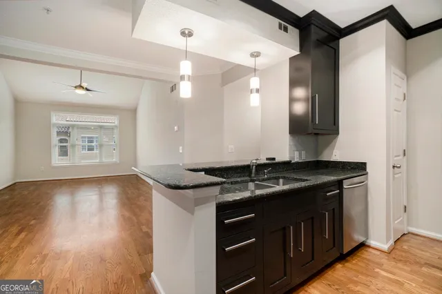 a bathroom with a granite countertop sink a vanity and a large mirror