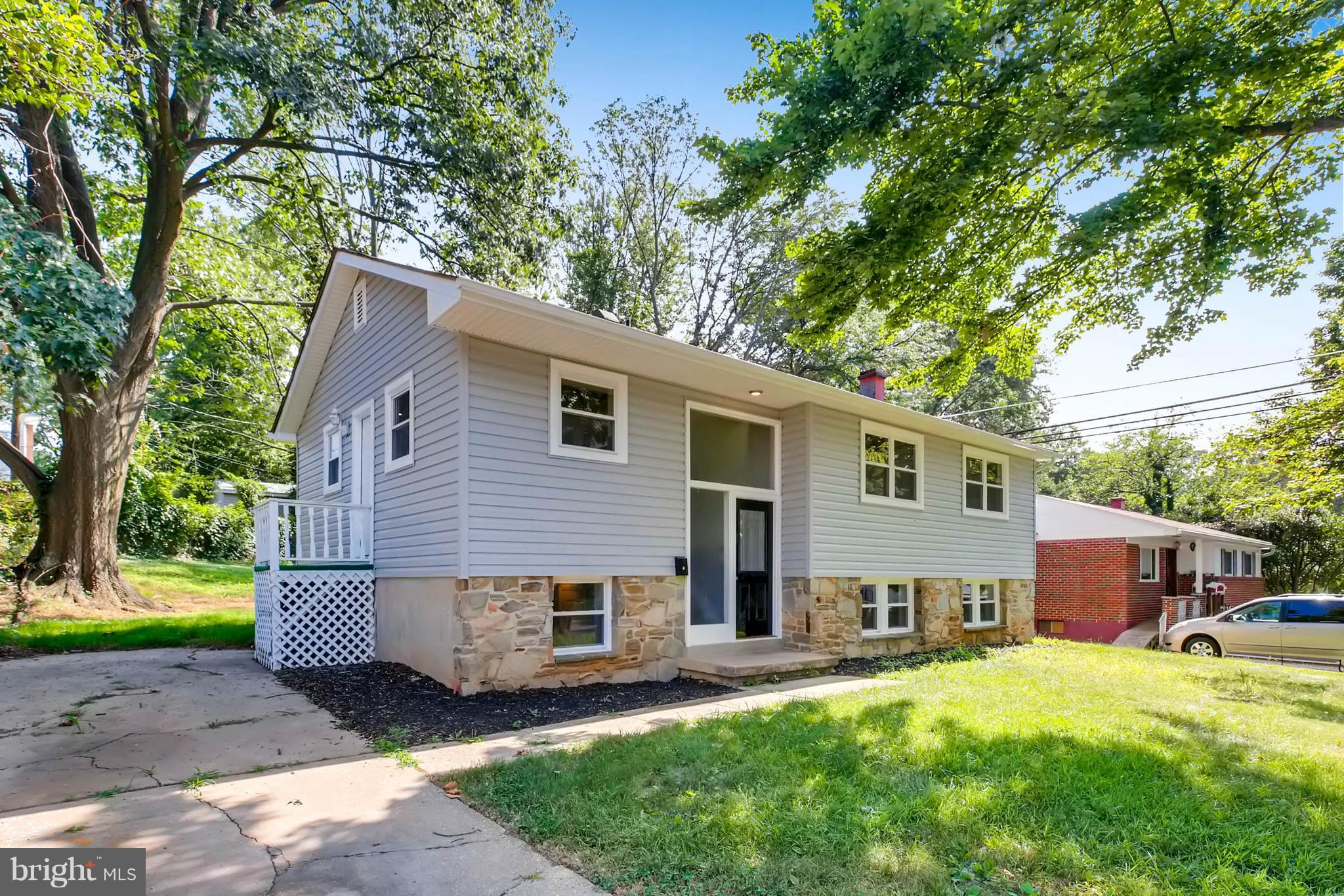 9020 Hamor Road Randallstown, MD 21133 - Photo 2 of 24 a view of a house with a yard and a large tree