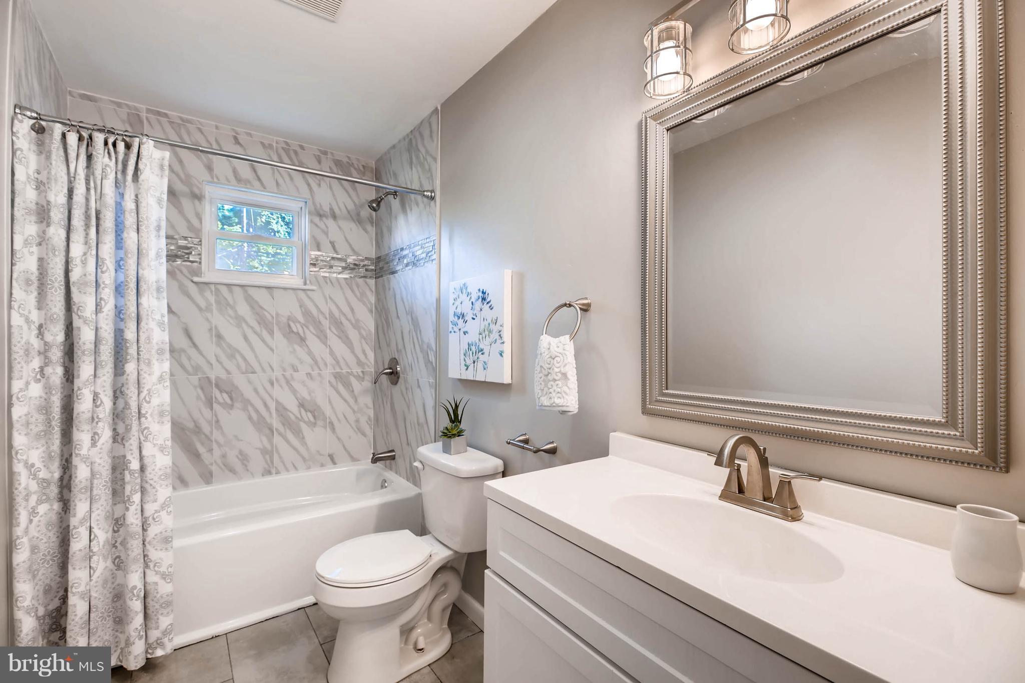 9020 Hamor Road Randallstown, MD 21133 - Photo 11 of 24 a bathroom with a sink a toilet and a bathtub