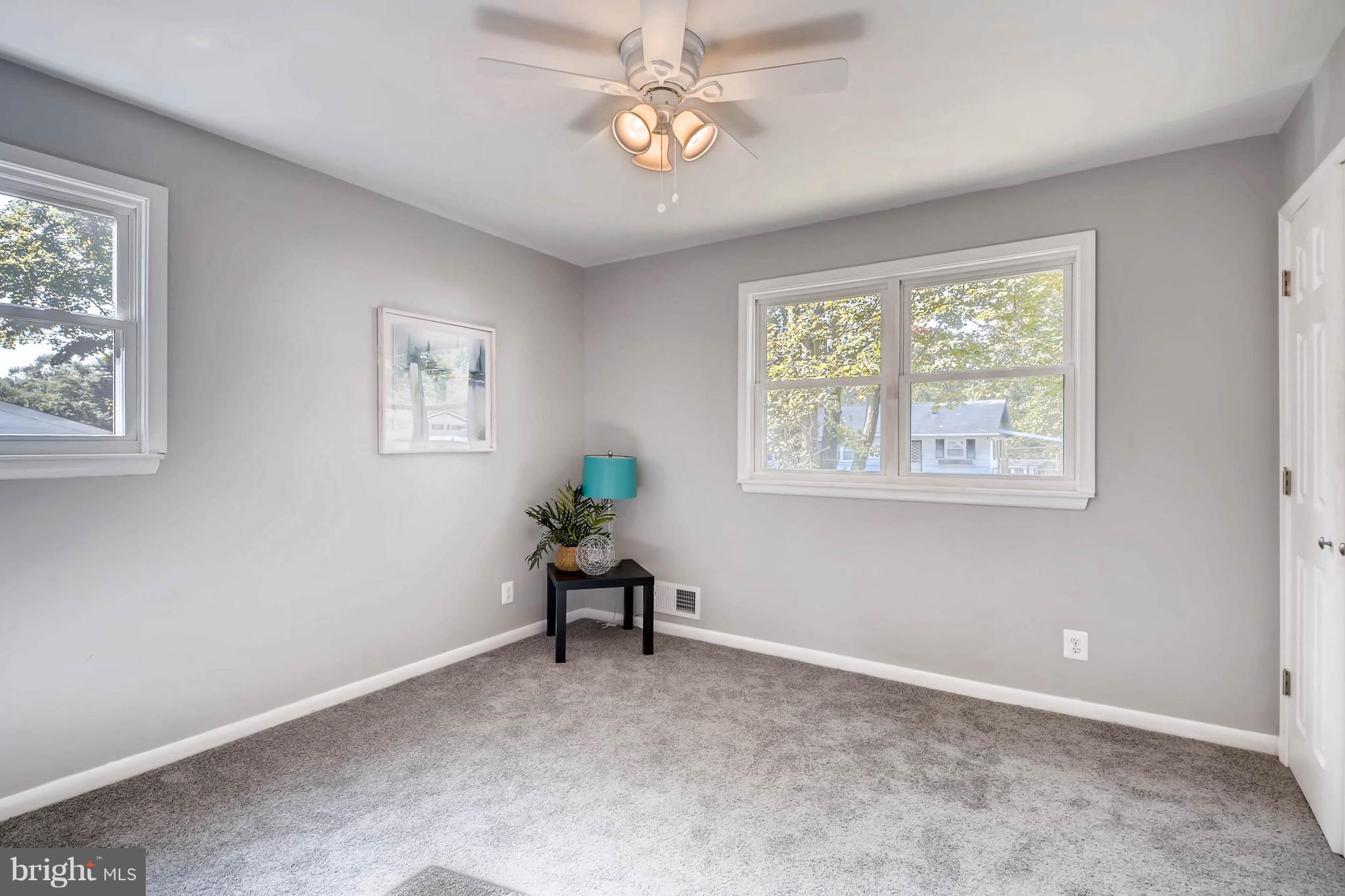 9020 Hamor Road Randallstown, MD 21133 - Photo 13 of 24 a view of workspace with wooden floor windows and chandelier fan
