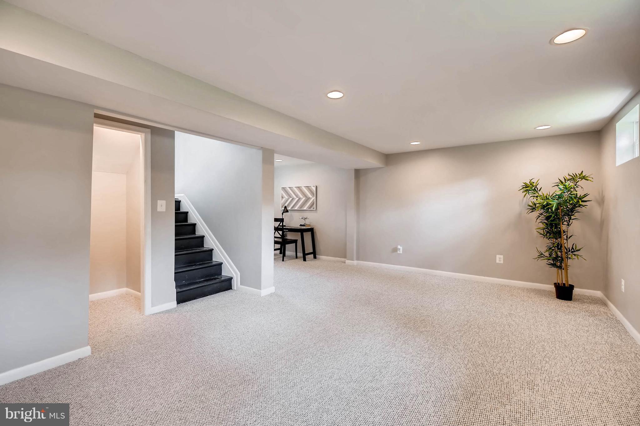 9020 Hamor Road Randallstown, MD 21133 - Photo 16 of 24 an empty room with wooden floor and stairs