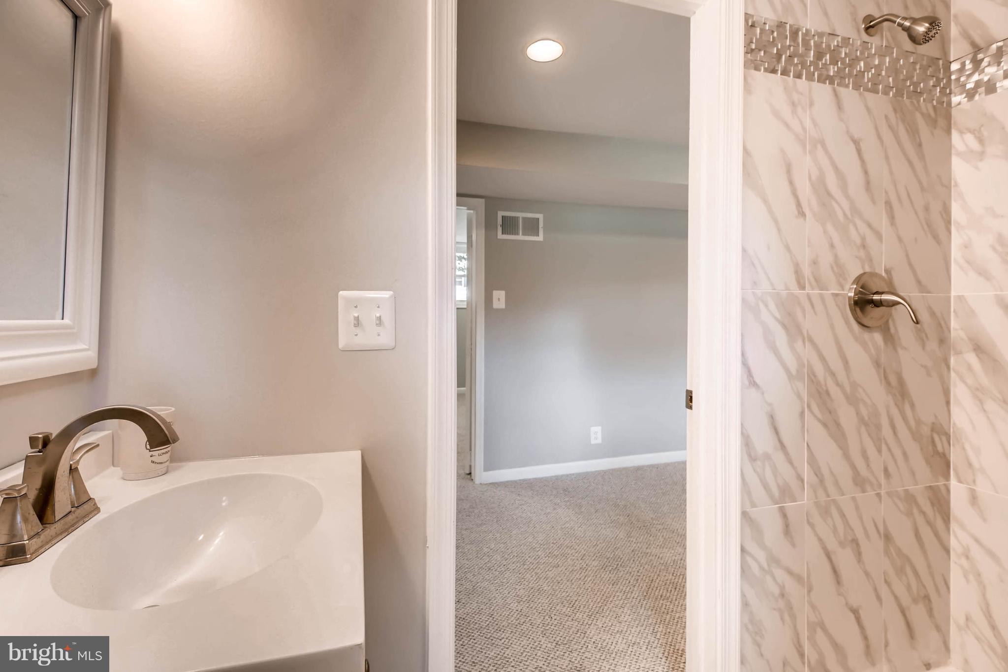 9020 Hamor Road Randallstown, MD 21133 - Photo 17 of 24 a bathroom with a sink and shower