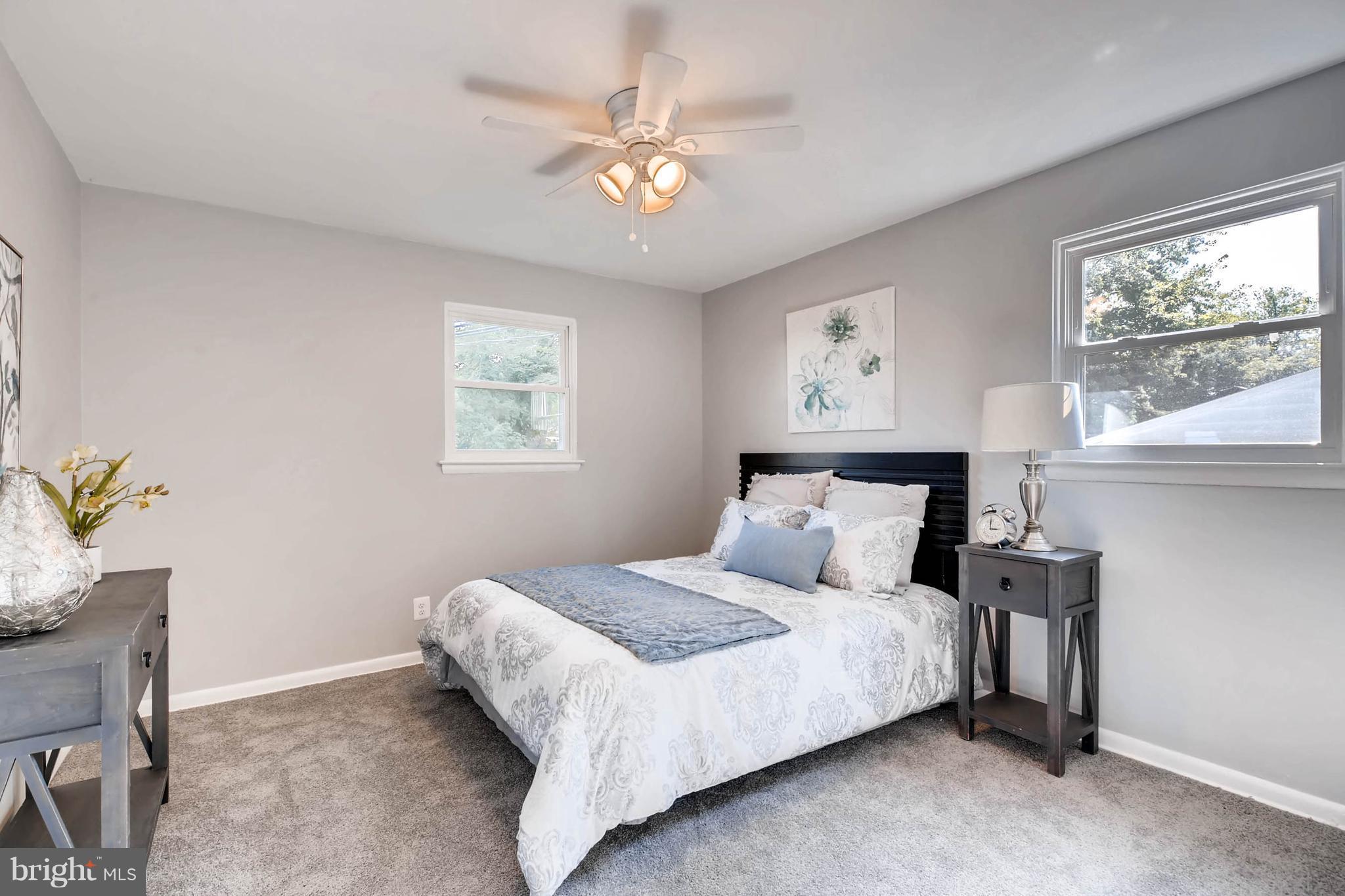 9020 Hamor Road Randallstown, MD 21133 - Photo 9 of 24 a bedroom with a bed and a chandelier