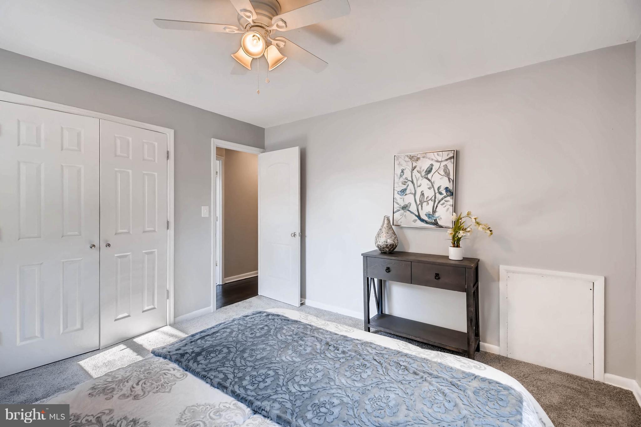 9020 Hamor Road Randallstown, MD 21133 - Photo 10 of 24 a bedroom with a bed and a chandelier