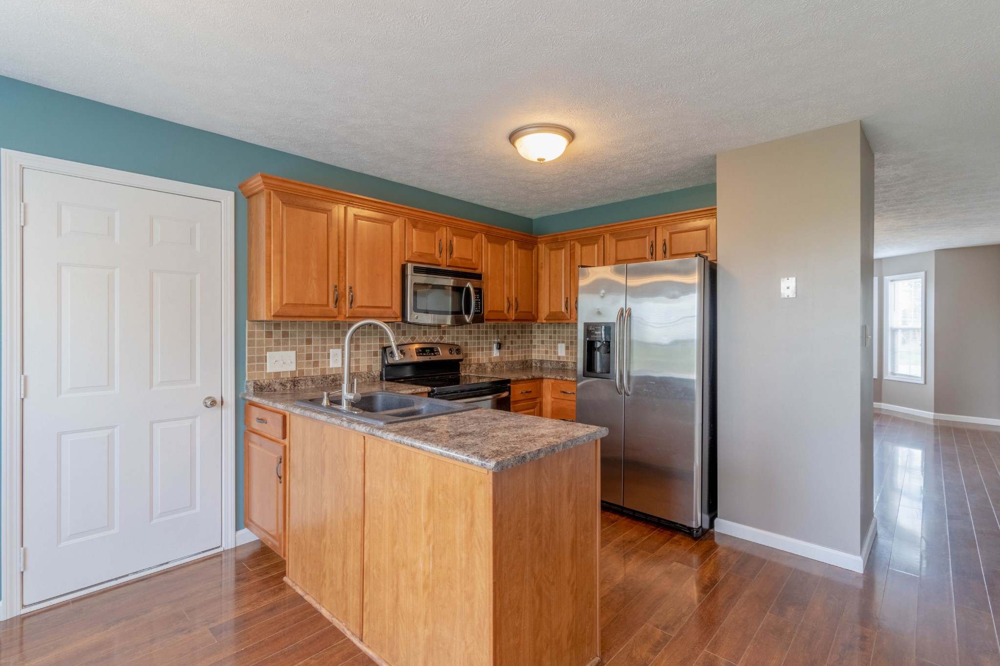 11241 Bell Station Road Oak Grove, KY 42262 - Photo 11 of 33 a kitchen with stainless steel appliances granite countertop a refrigerator a stove top oven a sink and dishwasher