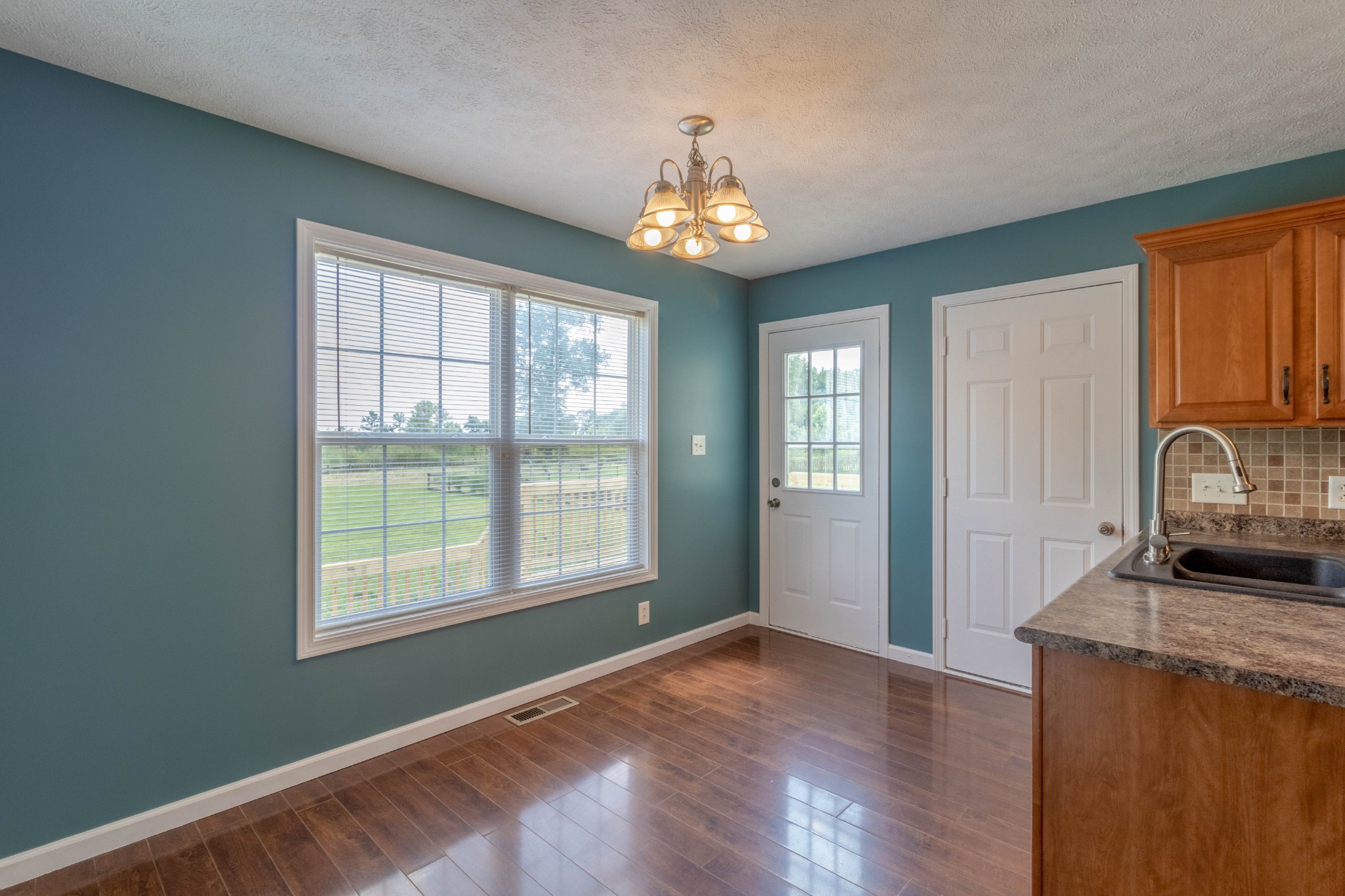 11241 Bell Station Road Oak Grove, KY 42262 - Photo 13 of 33 a view of an empty room with window and wooden floor