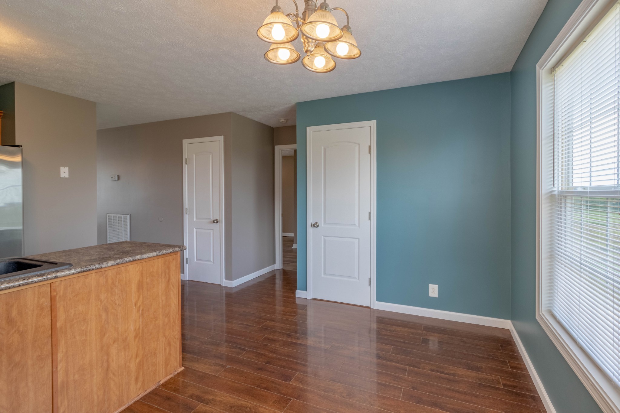 11241 Bell Station Road Oak Grove, KY 42262 - Photo 14 of 33 an empty room with wooden floor cabinet and windows