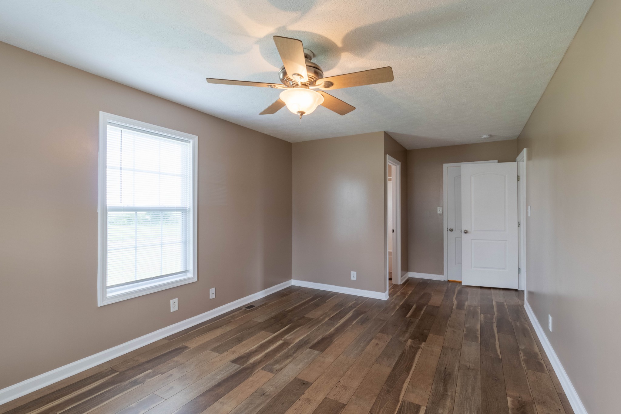 11241 Bell Station Road Oak Grove, KY 42262 - Photo 17 of 33 wooden floor in an empty room with a window