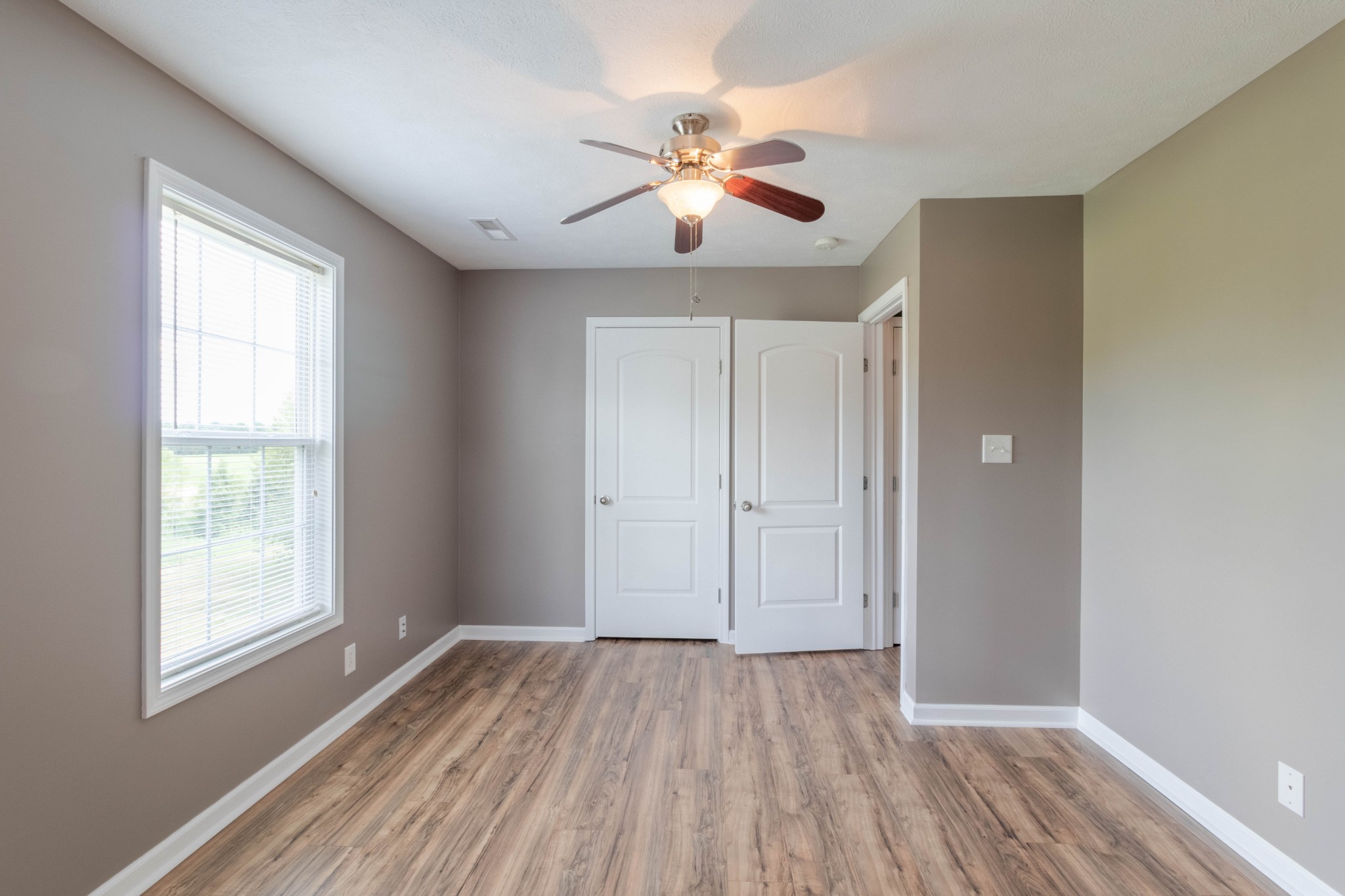 11241 Bell Station Road Oak Grove, KY 42262 - Photo 20 of 33 a view of an empty room with wooden floor and a window