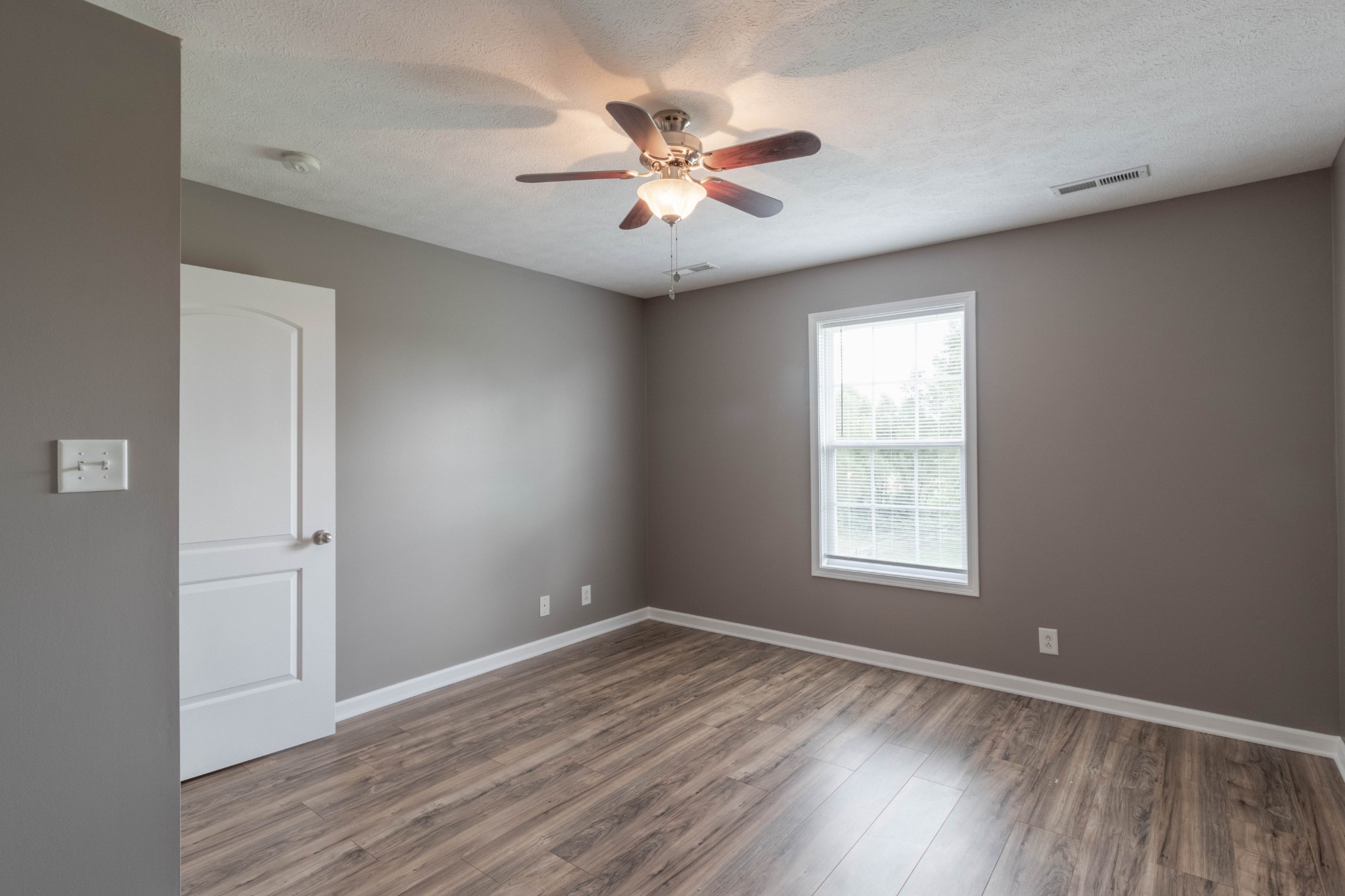 11241 Bell Station Road Oak Grove, KY 42262 - Photo 21 of 33 wooden floor in an empty room with a window