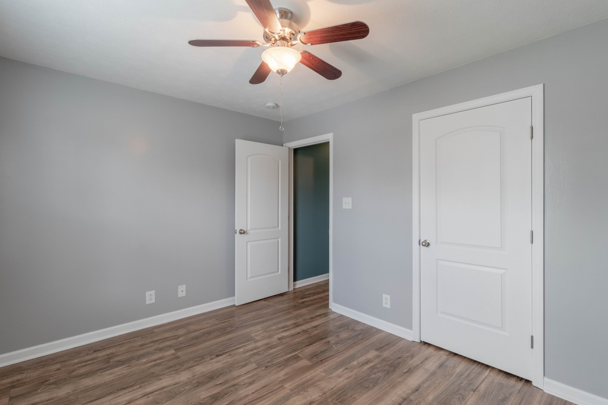 11241 Bell Station Road Oak Grove, KY 42262 - Photo 24 of 33 an empty room with wooden floor a ceiling fan and closet