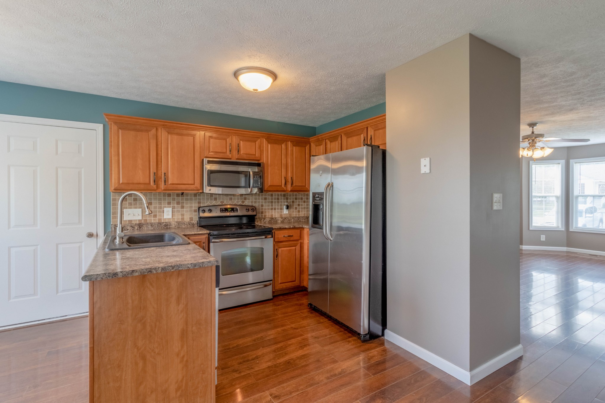 11241 Bell Station Road Oak Grove, KY 42262 - Photo 10 of 33 a kitchen with granite countertop stainless steel appliances and wooden cabinets