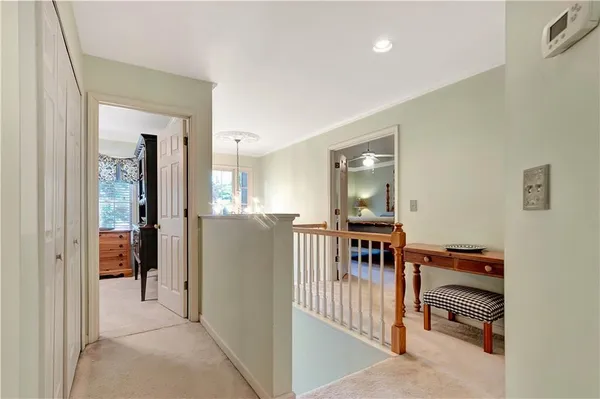 a view of a hallway with wooden floor and a window
