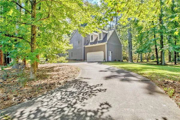 a view of a tree in the middle of a yard