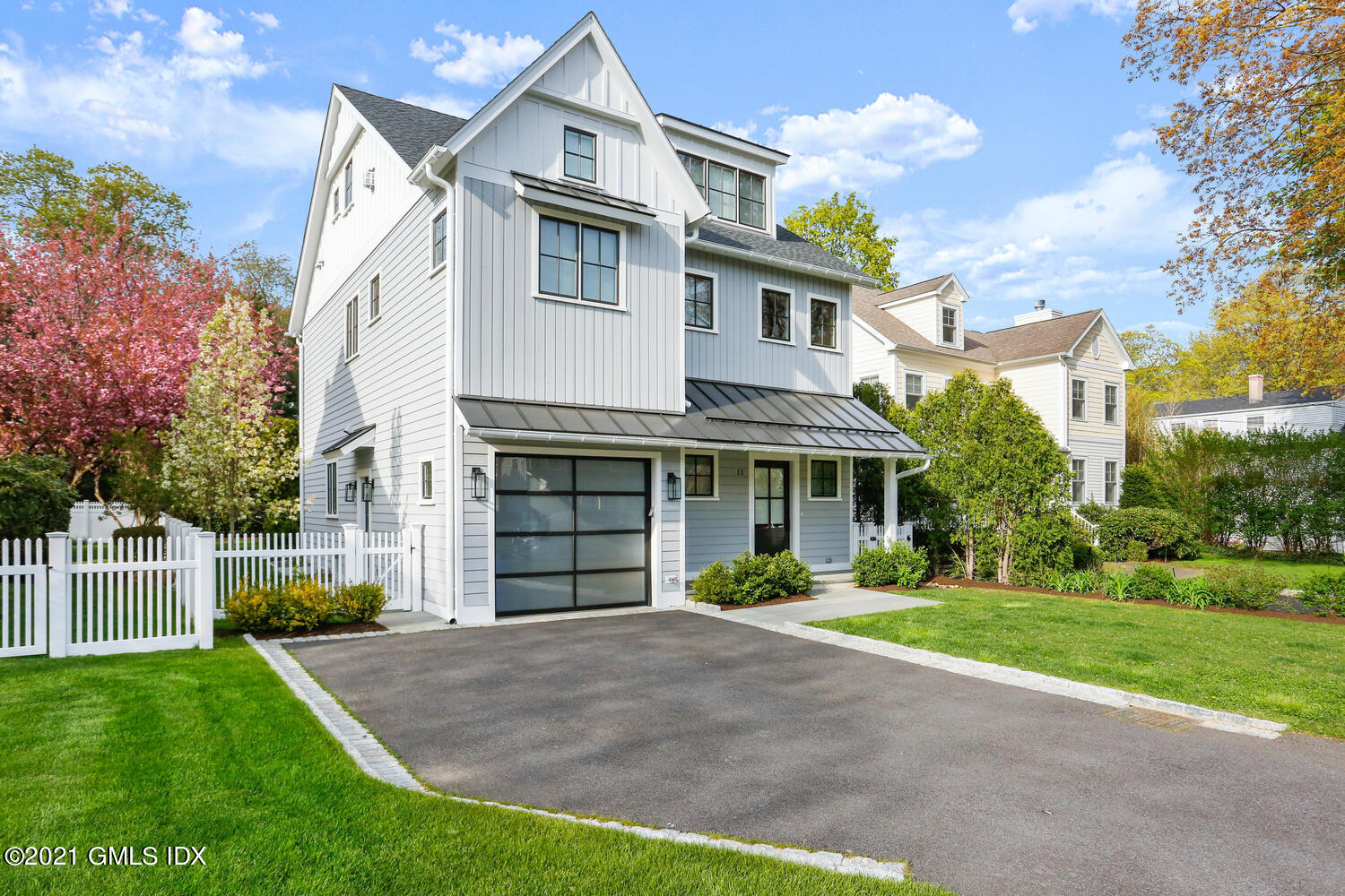 11 Anthony Place Riverside, CT 06878 - Photo 1 of 29 a front view of a house with a yard and potted plants