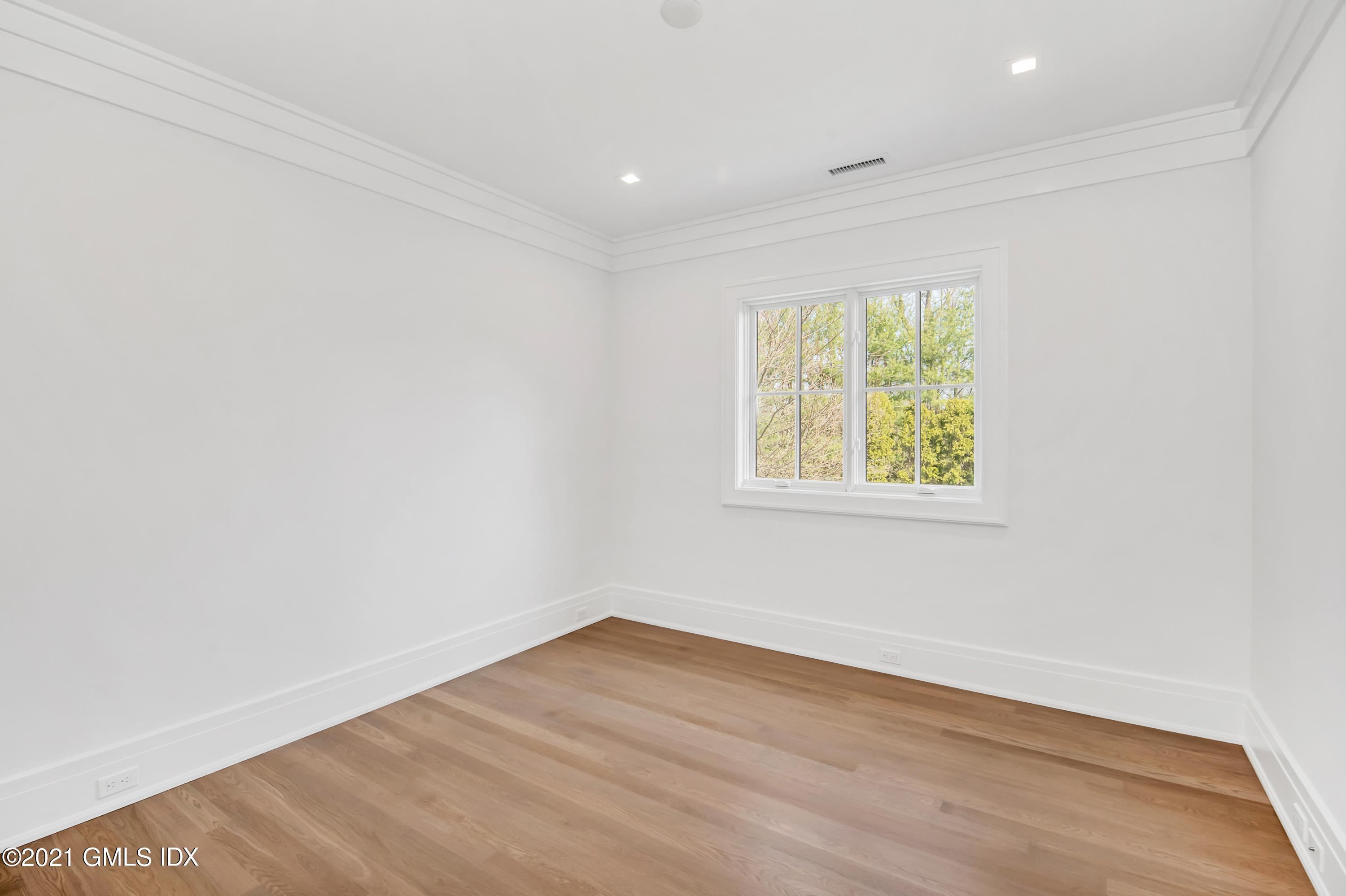 11 Anthony Place Riverside, CT 06878 - Photo 19 of 29 an empty room with wooden floor and windows
