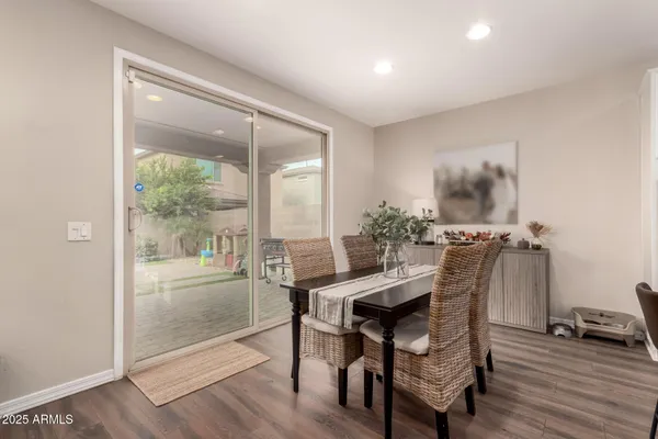 a kitchen with stainless steel appliances kitchen island a table and chairs in it