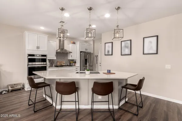 a kitchen with stainless steel appliances a refrigerator stove and sink