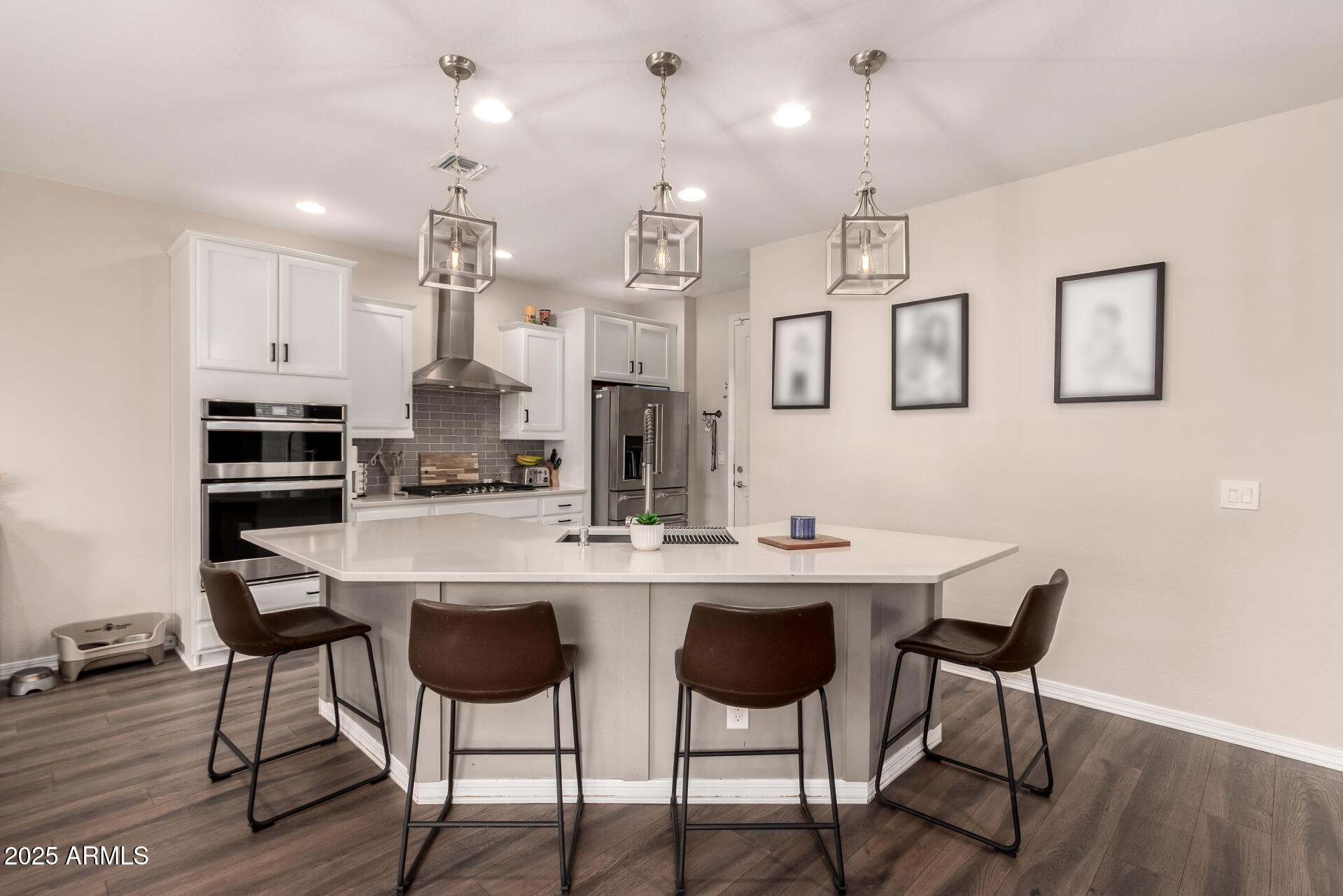5418 South Vincent Mesa, AZ 85212 - Photo 15 of 38 a kitchen with stainless steel appliances kitchen island a table and chairs in it