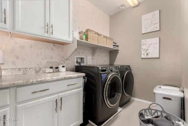a sitting area with couch on table and chairs