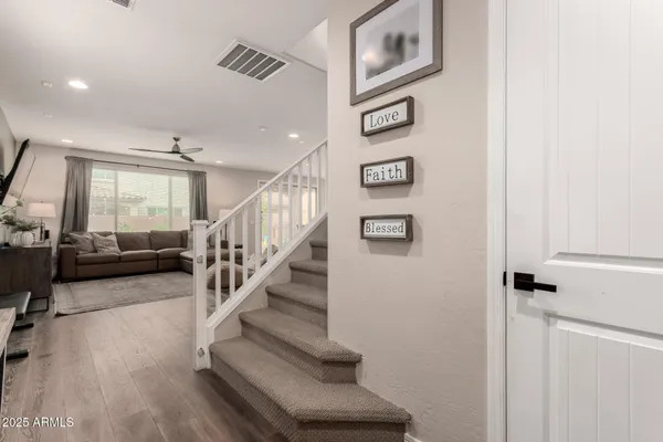a view of a hallway with wooden floor and entryway
