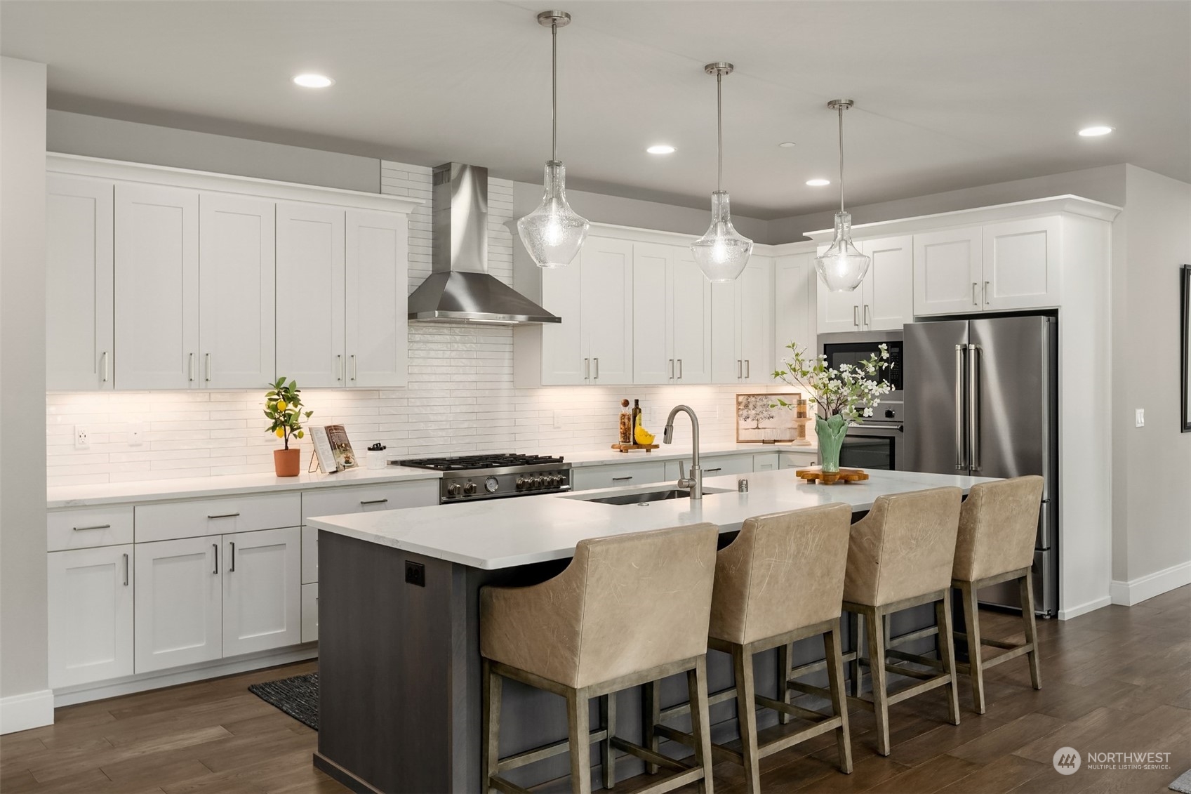 231 234th Place Southeast Bothell, WA 98021 - Photo 8 of 38 a kitchen with stainless steel appliances granite countertop a sink a stove a refrigerator and island with wooden floor