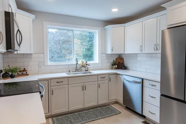 a bathroom with a toilet a sink and a window