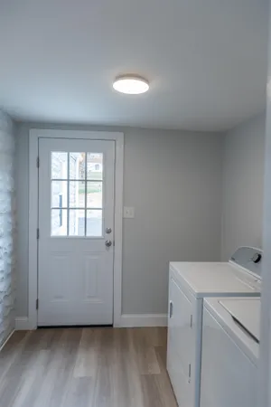 a vase of flowers sitting on a table with window