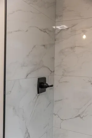 a white bath tub sitting next to a white toilet