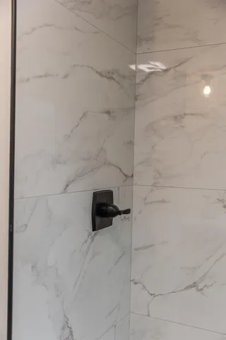 a white bath tub sitting next to a white toilet