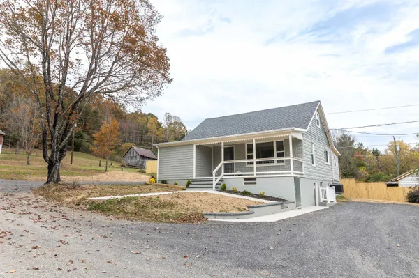 a view of a house with a yard and sitting area