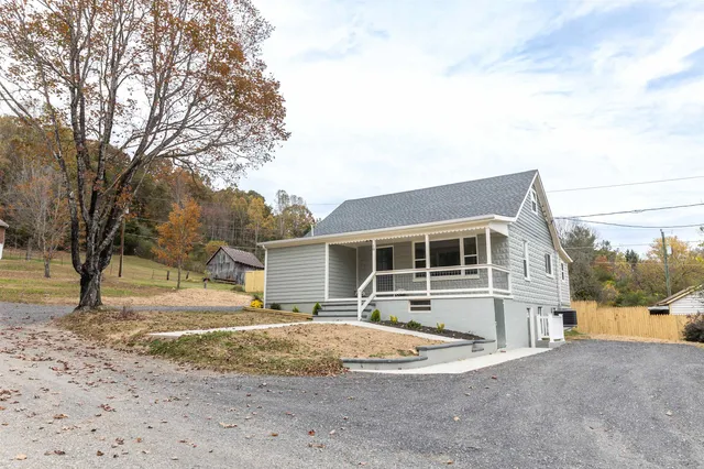 a view of a house with a yard and sitting area