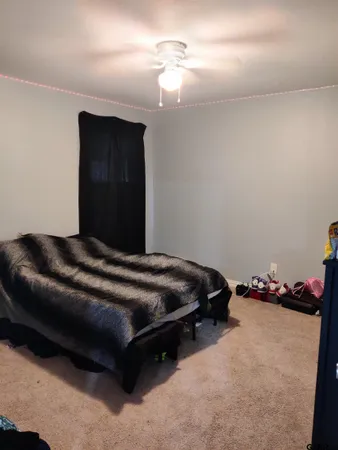 a bedroom with a bed and a lamp