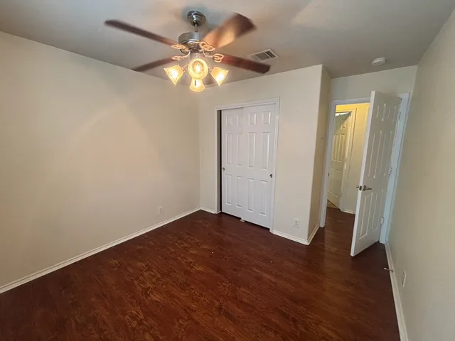 an empty room with wooden floor