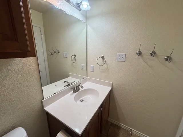 a bathroom with a sink a mirror and a toilet