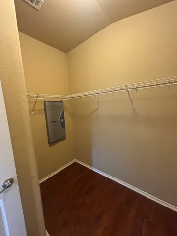 a view of a room with wooden floor and bench