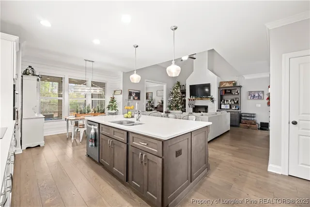 a large kitchen with lots of counter space and wooden floor