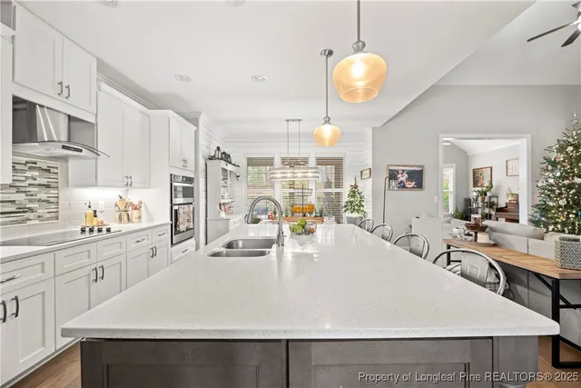a large white kitchen with lots of counter space and wooden floor
