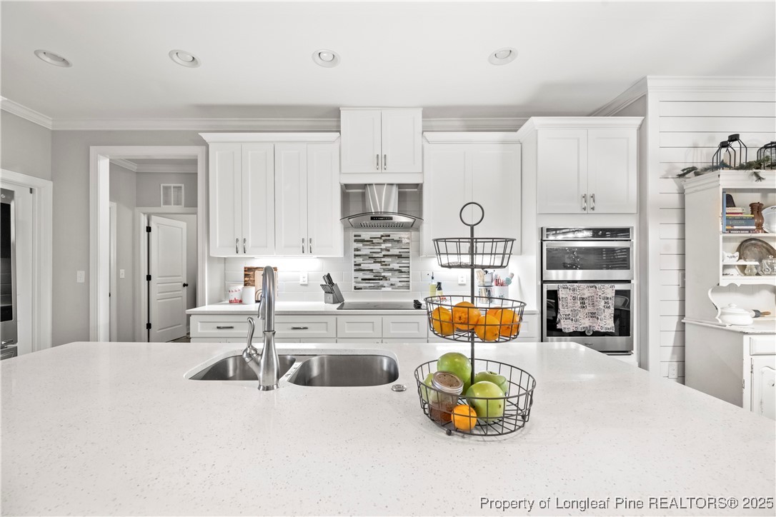 46 Brookhill Court Spring Lake, NC 28390 - Photo 17 of 50 a kitchen with stainless steel appliances kitchen island granite countertop a sink and cabinets