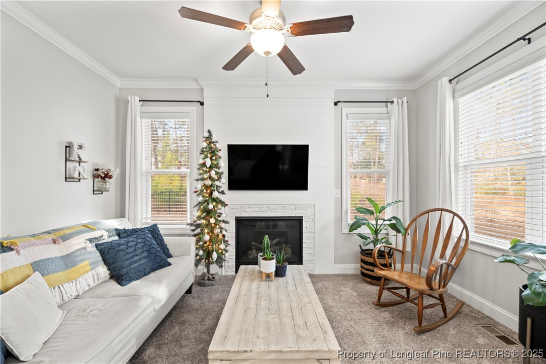 46 Brookhill Court Spring Lake, NC 28390 - Photo 22 of 50 a living room with furniture a flat screen tv and a fireplace