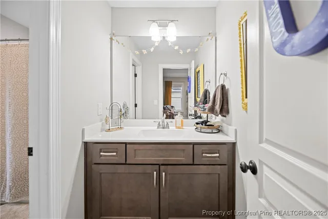a bathroom with a double vanity sink and a mirror