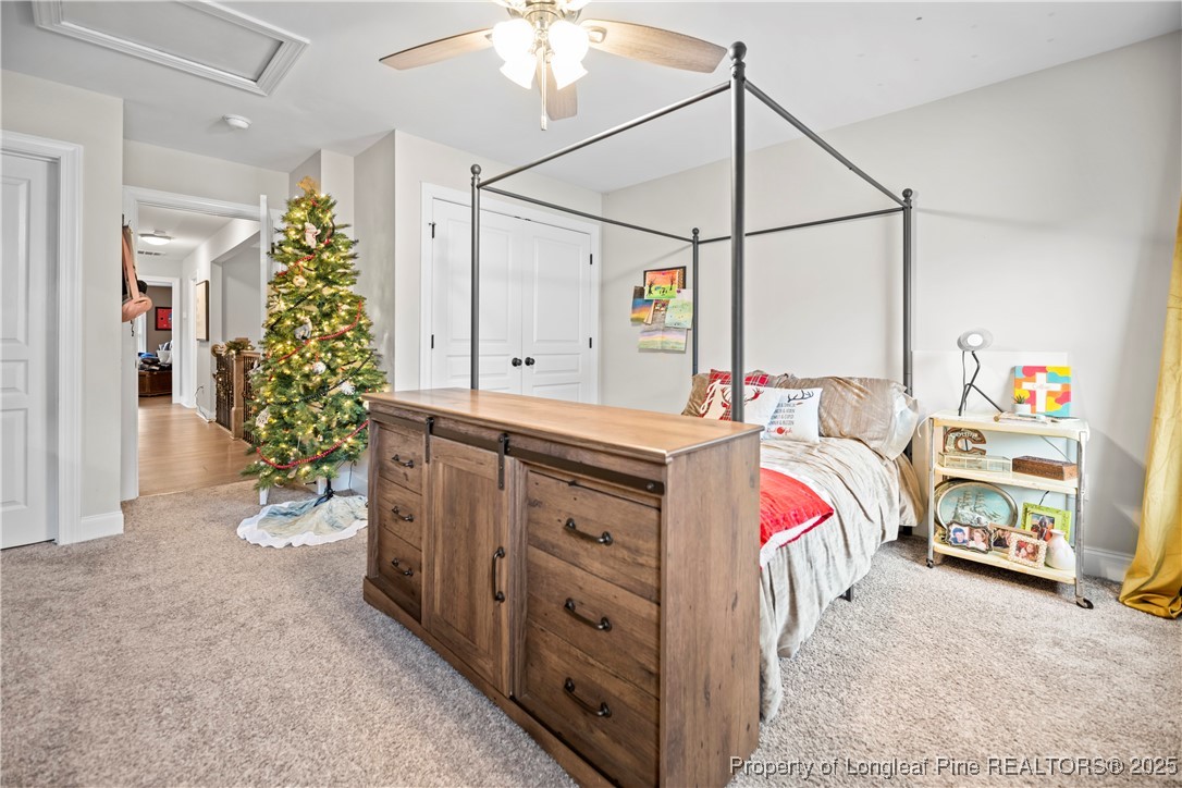 46 Brookhill Court Spring Lake, NC 28390 - Photo 34 of 50 a bedroom with a bed and a chandelier